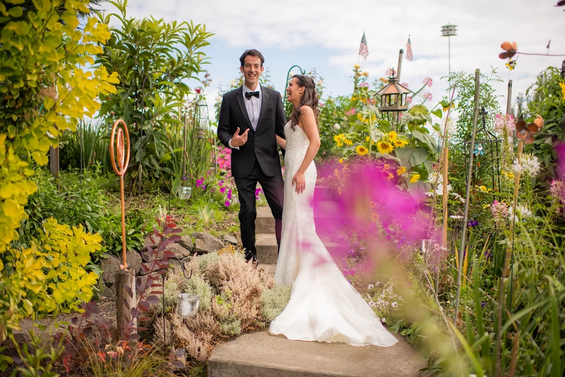 ​Sauvie Island Wedding  from  Photographer ​Robert Knapp  bride and groom stand together in a brightly colored flower garden at a A Sauvie Island Wedding from Photographer Robert Knapp