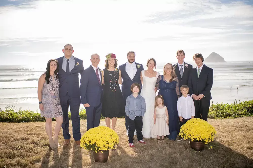 family photo with the beach in the background Wedding Photographers Near Me