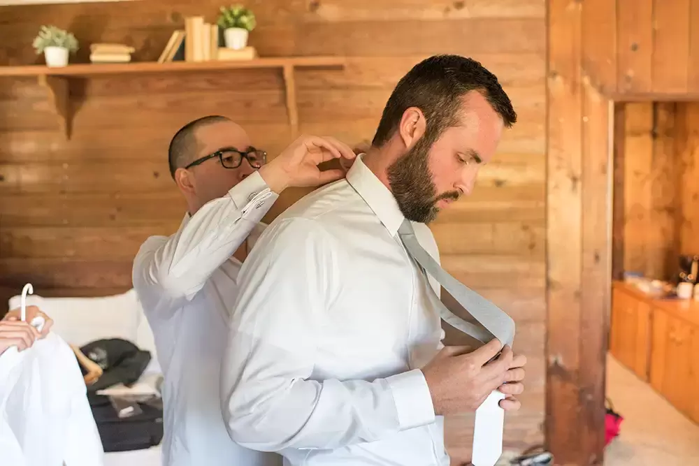 Tin Roof Weddings Barn Weddings Venues Near Me from Photographer Robert Knapp And helps the groom with his collar and tie