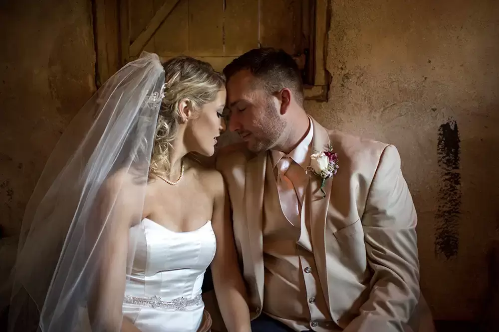 Portland Wedding Photographer Robert Knapp photographs a couple nuzzling inside a barn wedding