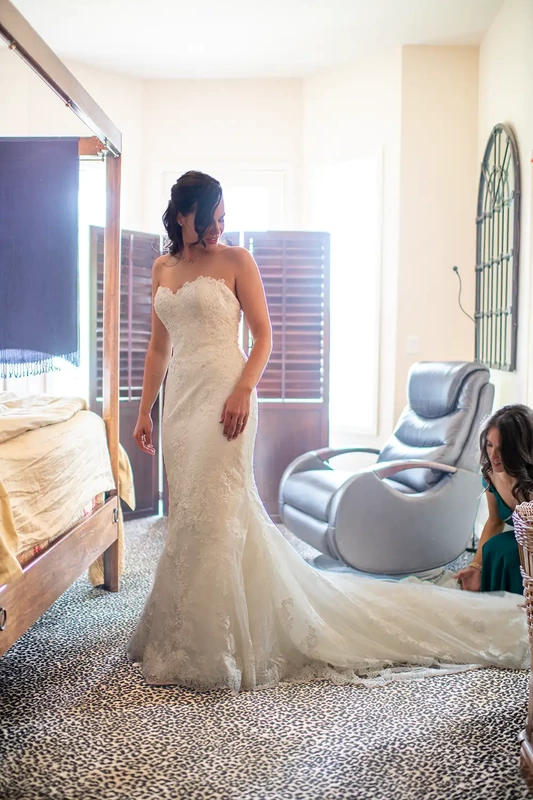 the bride puts on her wedding dress at A ​Sauvie Island Wedding from Photographer ​Robert Knapp 