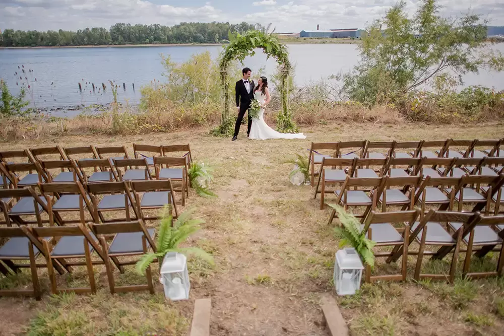 bride and groom stand at the empty ceremony locaton before the guests arrive at a A ​Sauvie Island Wedding from Photographer ​Robert Knapp 