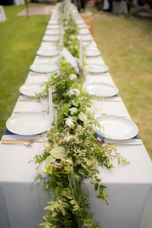 a long farmhouse style reception table at A ​Sauvie Island Wedding from Photographer ​Robert Knapp 