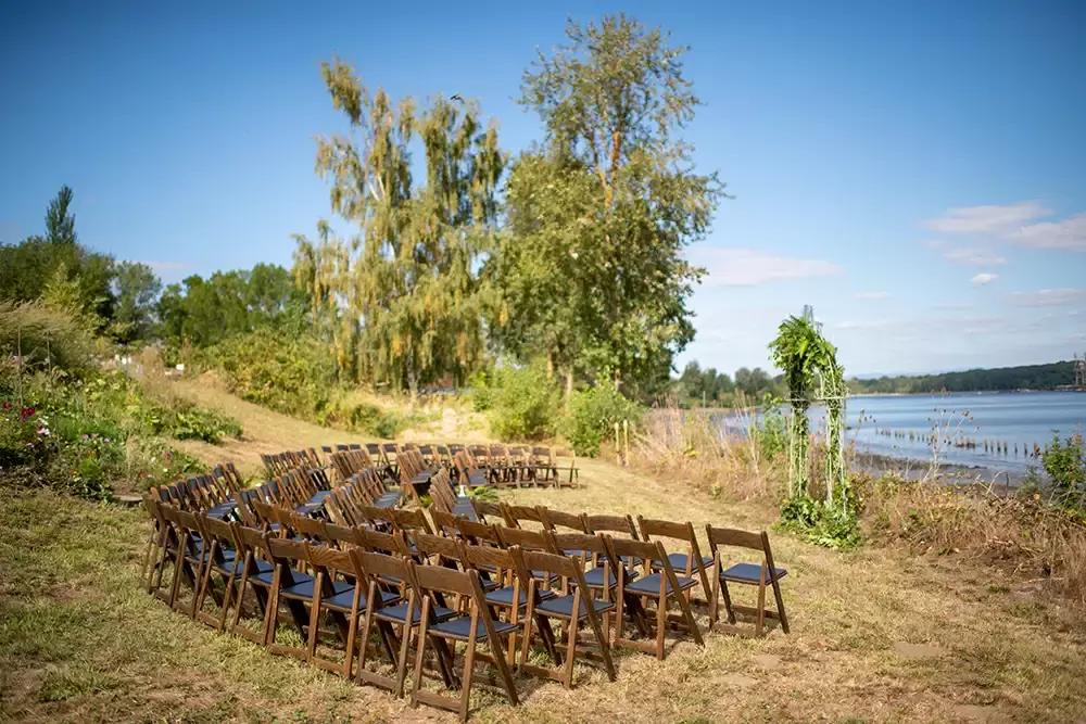 the chairs at the ceremony location overlooking the water at A ​Sauvie Island Wedding from Photographer ​Robert Knapp  