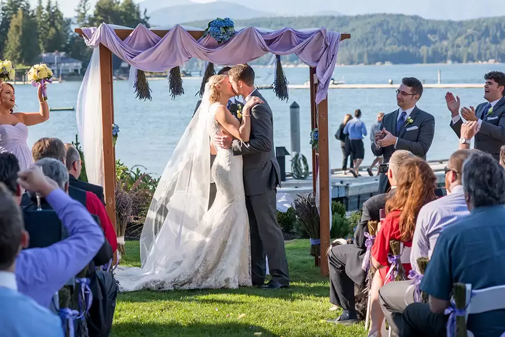 Alderbrook Resort Weddings with photographer Robert Knapp, bride and groom kiss at the ceremony
