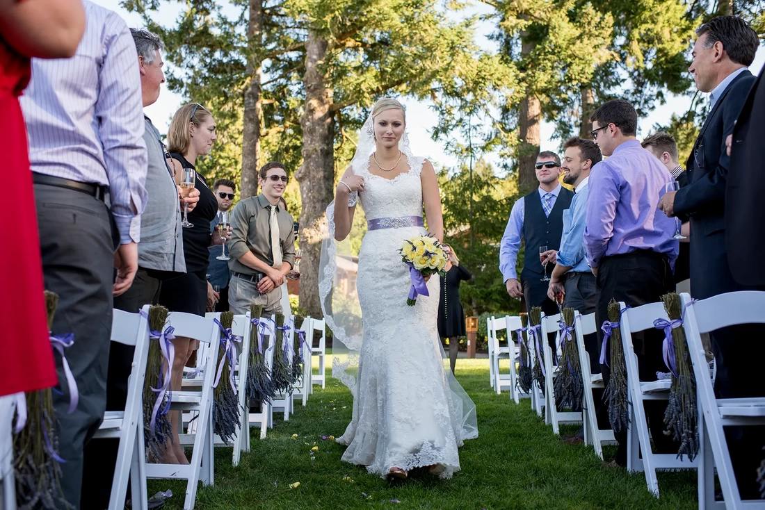 Bride walks down aisle by herself at Alderbrook Resort Weddings
