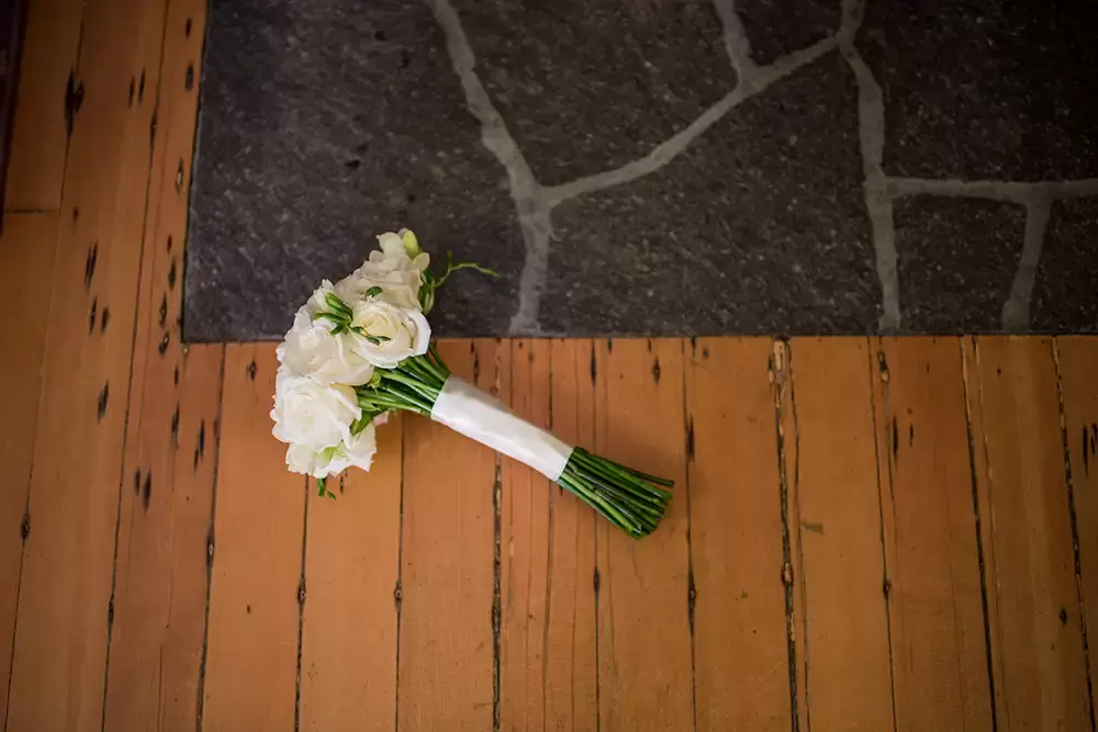 Wedding at Timberline Lodge the brides flowers rest on the hearth of the fire
