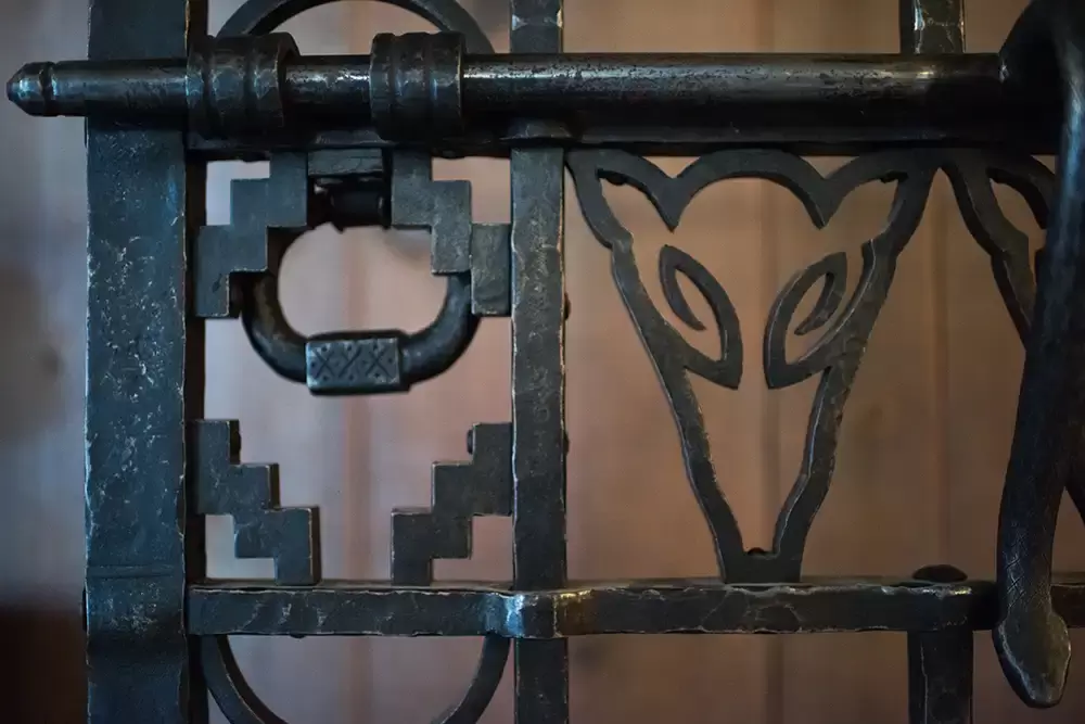 Breathtaking Photography from
a
Wedding at Timberline Lodge ironwork from the room of the wedding reception shows a lock and a handle and the face of a wild dog