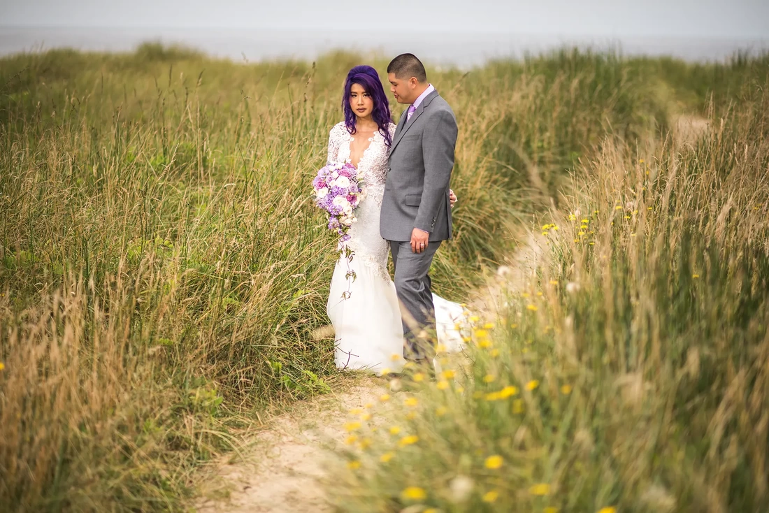 Bridal Photos at Cannon Beach by Photographer Robert Knapp bride and groom stand on a sand path 