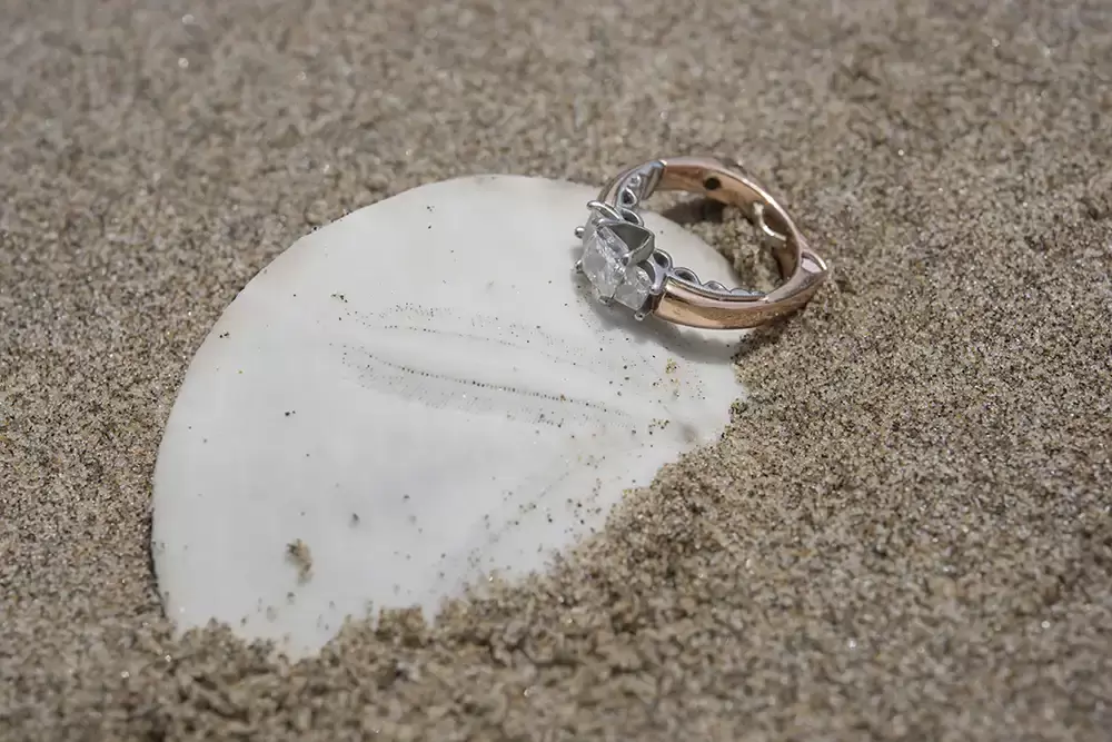a sand dollar and a engagement ring Cannon Beach Engagement Photos With Photographer Robert Knapp