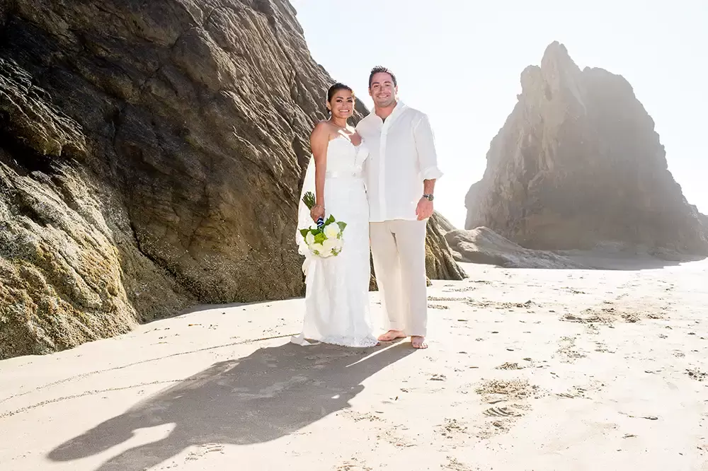 Wedding on the Beach
Cannon Beach Wedding
Photographer Robert Knapp rocks and sand on the beach, the bride and groom smile and look to the camera