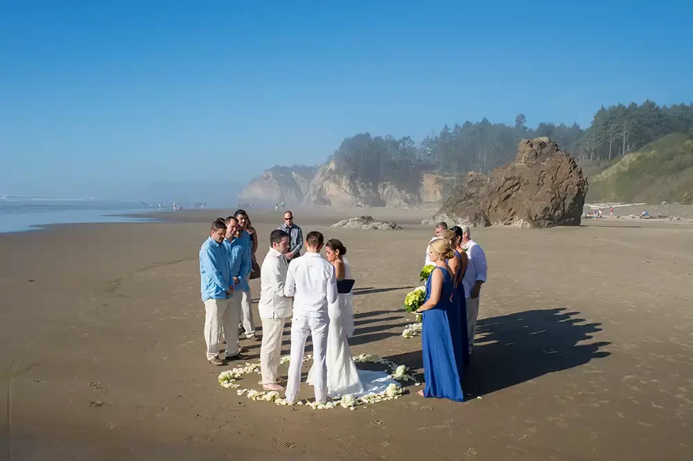 Wedding on the Beach
Cannon Beach Wedding
Photographer Robert Knapp the ceremony from behind shows an small ceremony with maybe 12-15 guests