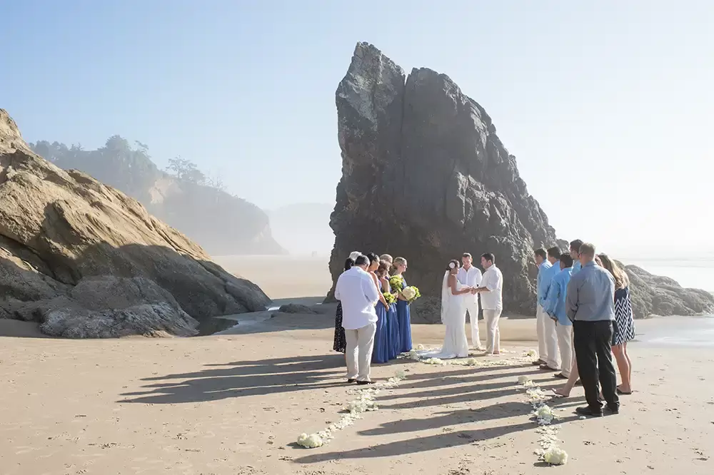 Wedding on the Beach
Cannon Beach Wedding
Photographer Robert Knapp The ceremony continues, the jagged rocks around are prominent 