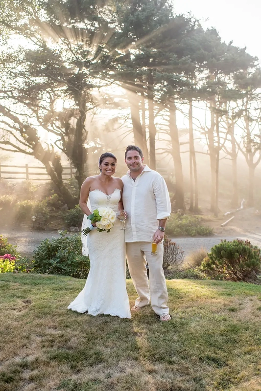 Wedding on the Beach
Cannon Beach Wedding
Photographer Robert Knapp Sea fog mixes with sunlight shining through the trees creating the illusion that the sunlight is shooting in all directions. Bride and groom look to the camera in the amber light.