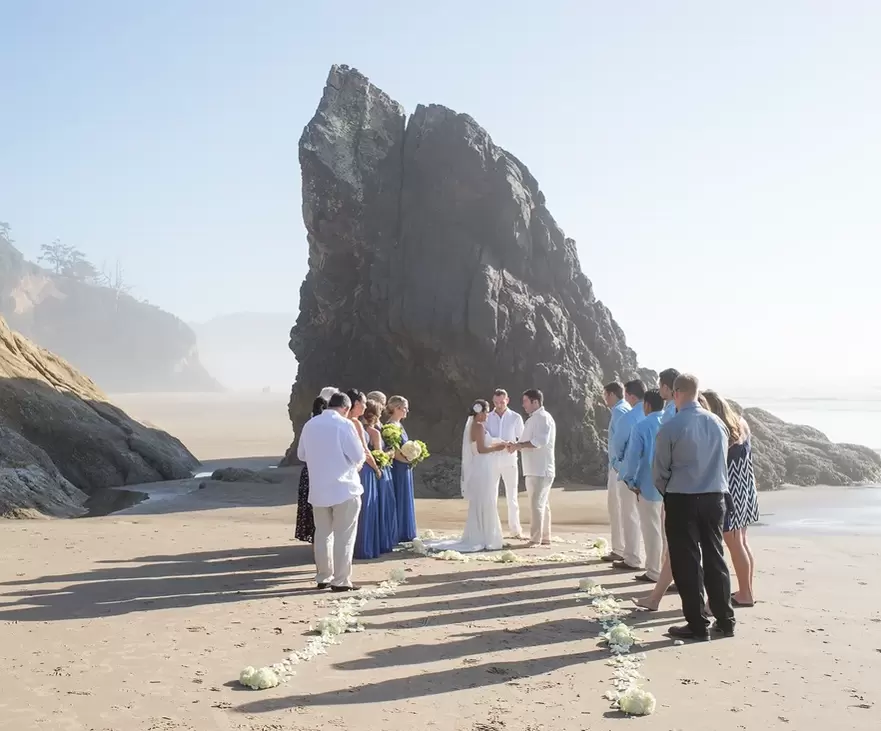 Wedding on the Beach Cannon Beach Wedding Photographer Robert Knapp The wedding ceremony on a hazy day at the beach. The sun is overpowering the fog the ceremony is underway