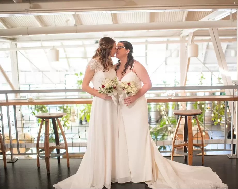 LGBTQ Wedding Photographer Robert Knapp at Cooper Hall - Love is Love two brides have a kiss and hold their bouquets Love is Love - Experience LGBTQ Wedding Photography with Robert Knapp at Cooper Hall