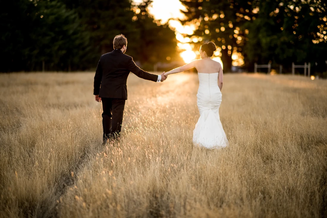 Bride and groom walk into the sunset