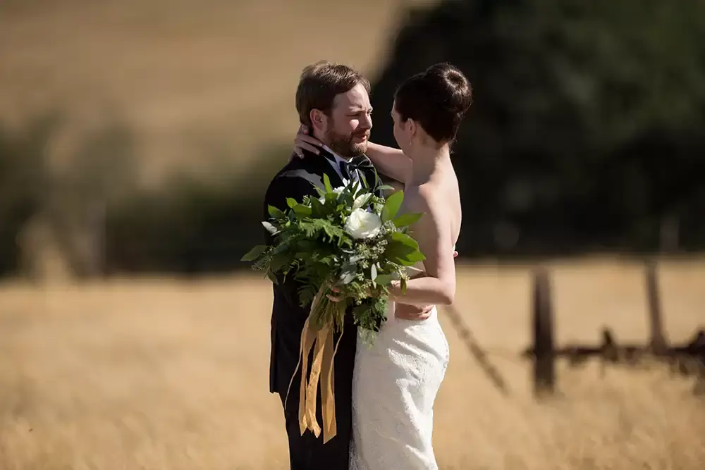 Farm Wedding Oregon
Rustic ​Chic Style with Robert Knapp Photographer the bride wraps her arm around the neck of the groom. 