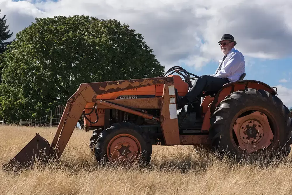 Farm Wedding Oregon
Rustic ​Chic Style with Robert Knapp Photographer Father of the groom sits on top of a tractor in semi formal attire. Just to be funny I think. No chores are to be done today. 