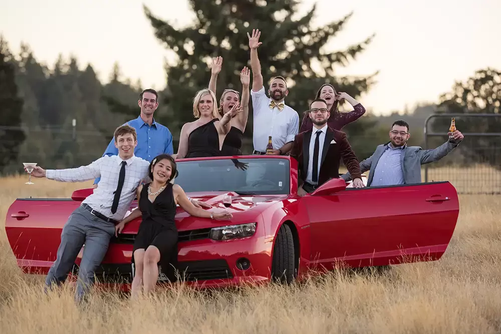 Farm Wedding Oregon
Rustic ​Chic Style with Robert Knapp Photographer Many wedding guests all stand all over a rental car. thy hold drinks and look festive. 