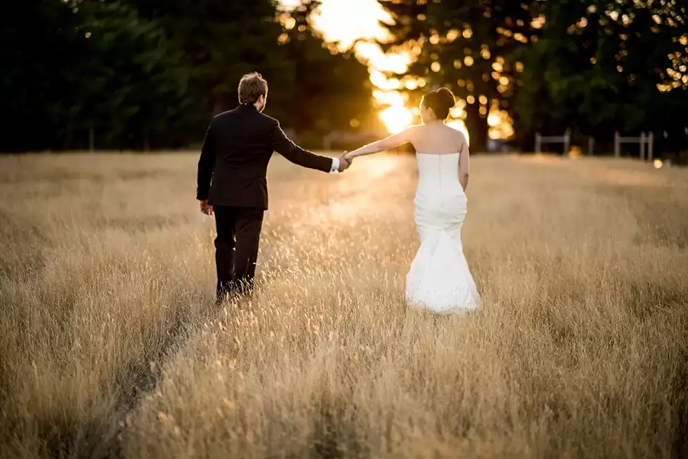 Farm Wedding Oregon
Rustic ​Chic Style with Robert Knapp Photographer sunset wedding photos from a oregon farm wedding a couple holds hands and walks to the sunset