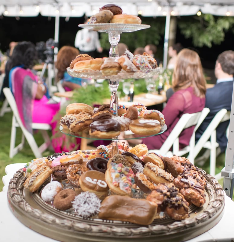 Farm Wedding Oregon Rustic ​Chic Style with Robert Knapp Photographer A collection of doughnuts sits on desert tower. The doughnuts are all brightly colored. 