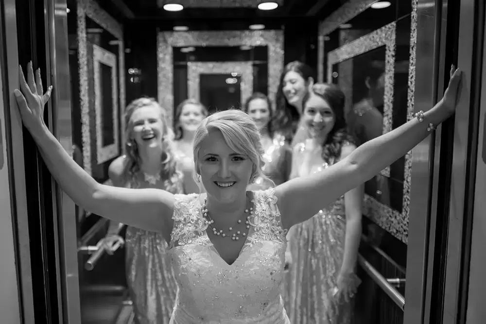 Hotel Deluxe Wedding in Portland Oregon
by Photographer Robert Knapp bride and bridesmaids in the lift feeling very proud and excited. 