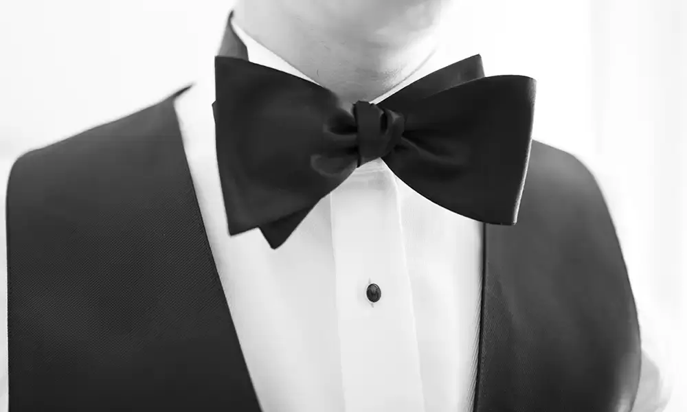 Hotel Deluxe Wedding in Portland Oregon
by Photographer Robert Knapp close up of a massive bow tie on the neck of the groom