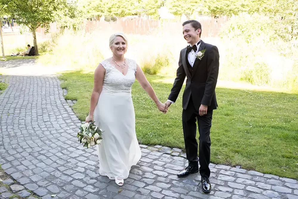 Hotel Deluxe Wedding in Portland Oregon
by Photographer Robert Knapp bride and groom hold hands on a cobblestone path