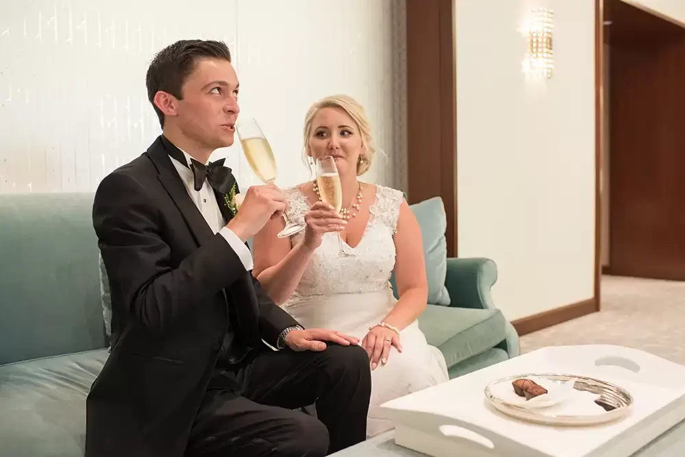 Hotel Deluxe Wedding in Portland Oregon
by Photographer Robert Knapp bride and groom sip champagne and eat chocolate in the Tiffany jewelry shop