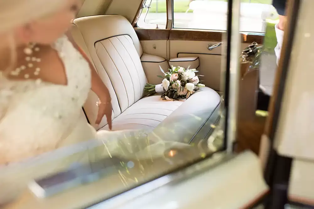 Hotel Deluxe Wedding in Portland Oregon
by Photographer Robert Knapp photo of the back seat of the rolls royce, the bouquet sits on the end of the seat. the bride gets in. 