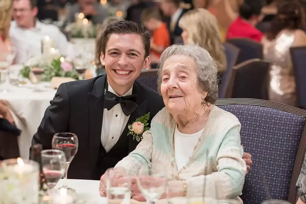 Hotel Deluxe Wedding in Portland Oregon
by Photographer Robert Knapp groom sits with his grandmother, they smile at the camera