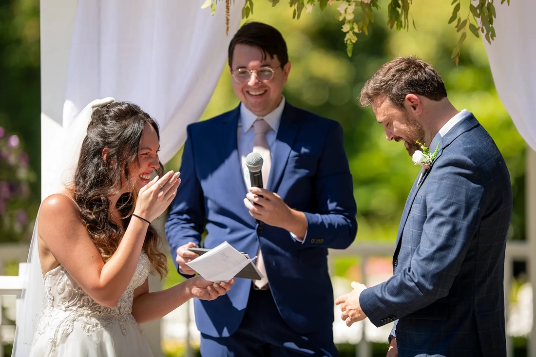 the groom fumbles during the ceremony and the bride as a great laugh, the smiles are so genuine, lakeside garden wedding 