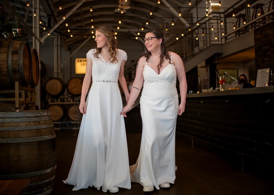 LGBTQ Wedding Photographer Robert Knapp at Cooper Hall - Love is Lovetwo bries hold hands and walk toward the camera, Love is Love - Experience LGBTQ Wedding Photography with Robert Knapp at Cooper Hall