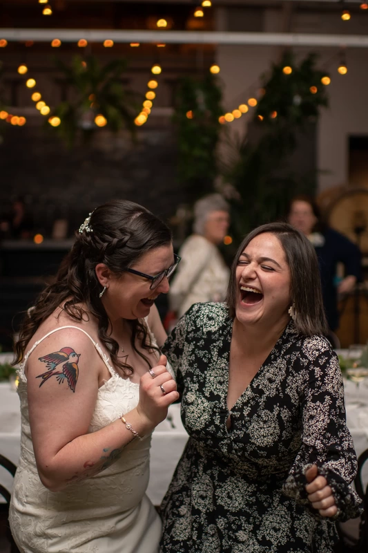 LGBTQ Wedding Photographer Robert Knapp at Cooper Hall - Love is Love bride laughs with an old friend Love is Love - See the work of LGBTQ Wedding Photographer Robert Knapp at Cooper Hall