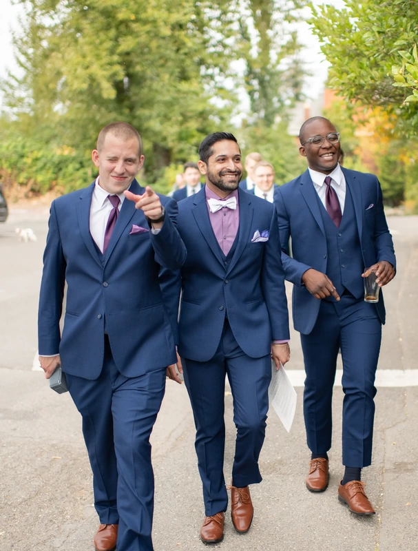 McMenamins Edgefield Weddings with groomsmen in blue suits walking to the reception 