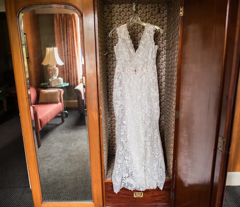 ​McMenamins Grand Lodge Weddings 
from Robert Knapp Photographer A wedding dress hangs inside a vintage wardrobe closet. The mirror reflects a vintage decor room