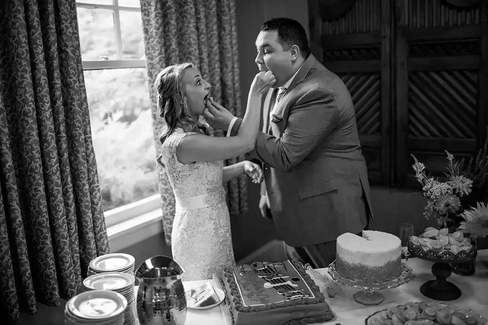 ​McMenamins Grand Lodge Weddings 
from Robert Knapp Photographer bride and groom feed each other cake at McMenamins Grand Lodge Weddings 
