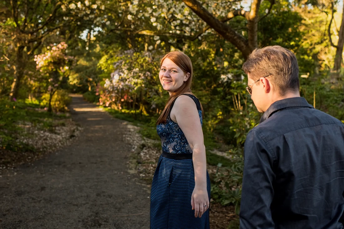 a man and a woman walk on a forested path Modern Art Photograph Engagement Photography Portland Oregon​