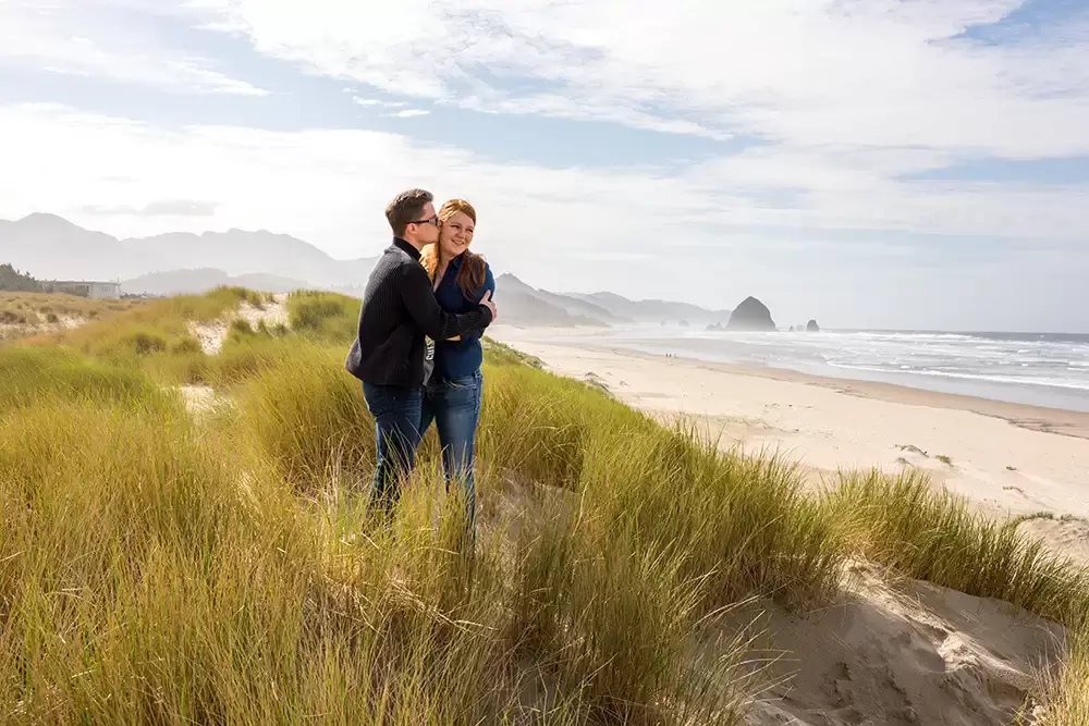 man kisses woman on the cheek at cannon beach Modern Art Photograph 
Engagement Photography Portland Oregon