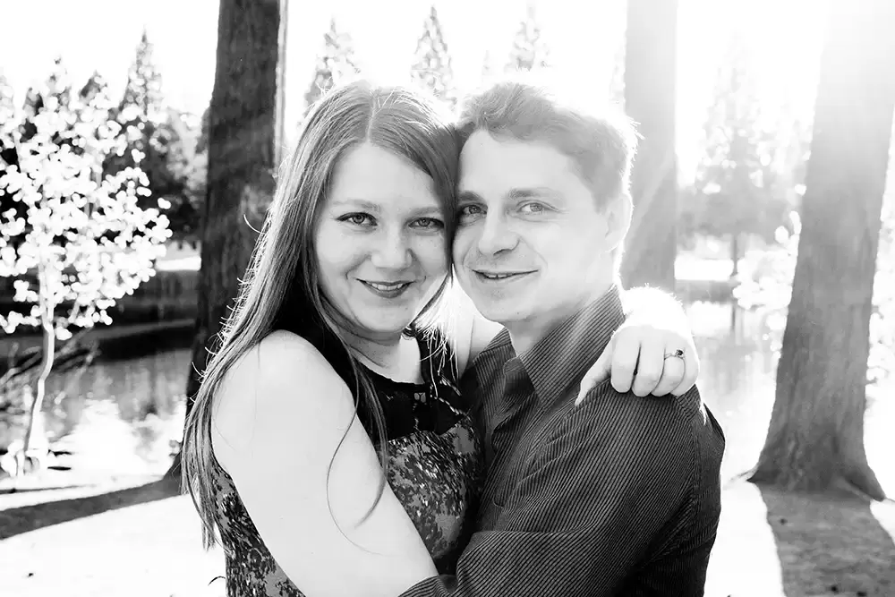 solar flare over the shoulders of a couple hugging Modern Art Photograph 
Engagement Photography Portland Oregon