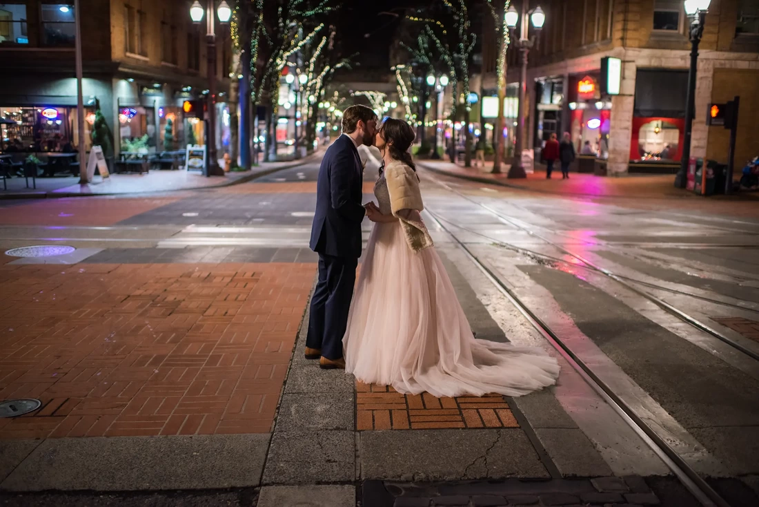 Wedding Photographers in Portland on location at the  Portland Sentinel Hotel bride and groom kiss on the street outside at night with Wedding Photographers in Portland shooting on location at the Portland Sentinel Hotel