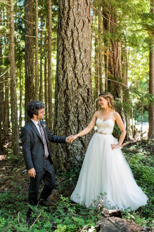 Mount Hood Weddings Capturing The Moment with Photojournalist Wedding Photographer Robert Knapp  offer locations just like this amazing photo of a groom holding a brides hand in the woods