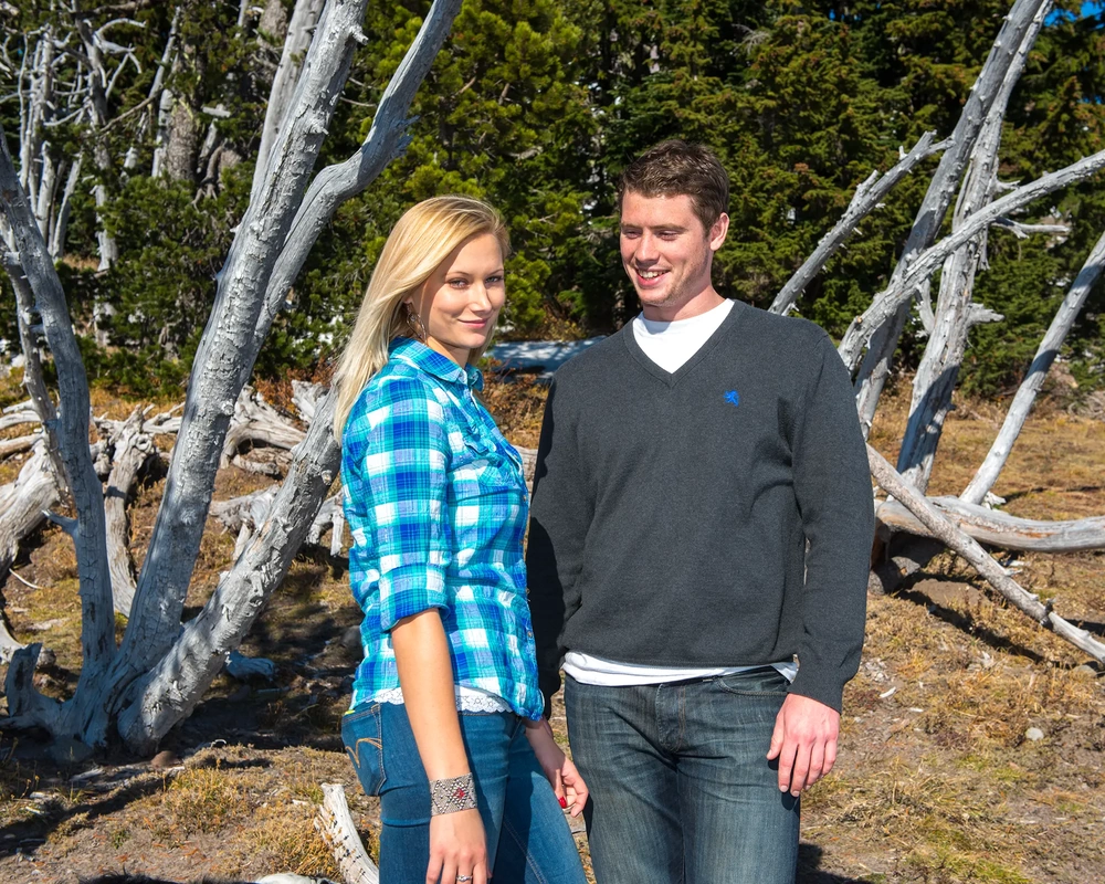 Mountain Engagement Photos a couple stands high in alpine meadow