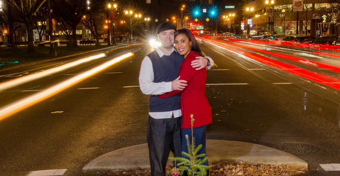 Nighttime Engagement Photos with Modern art Photograph in Portland Oregon Traffic blurs with a long exposure . the couple holds their pose for a very long time and the photo worked out great 