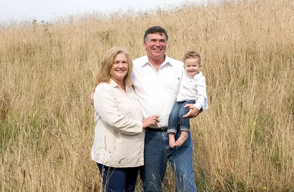 grandma and grandpa and baby stand in the autumn grasses Oregon Coast Engagement Photos 
With 
Modern Art Photograph