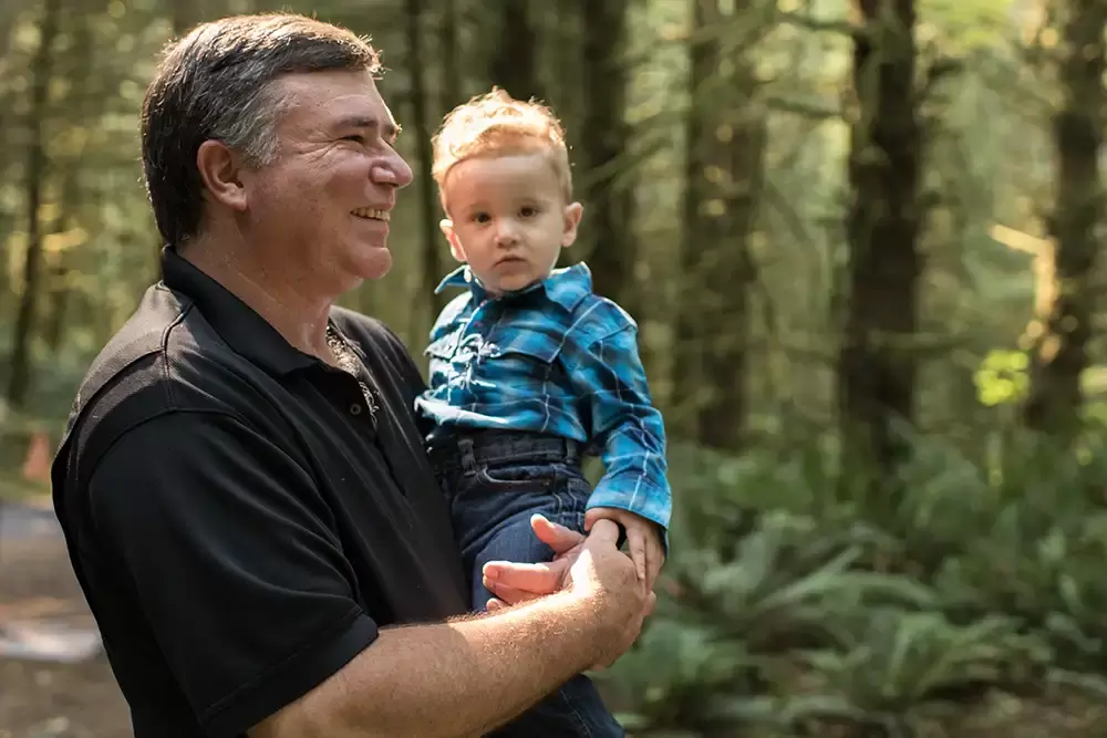grandpa and grandson stand in the woods together Oregon Coast Engagement Photos 
With 
Modern Art Photograph