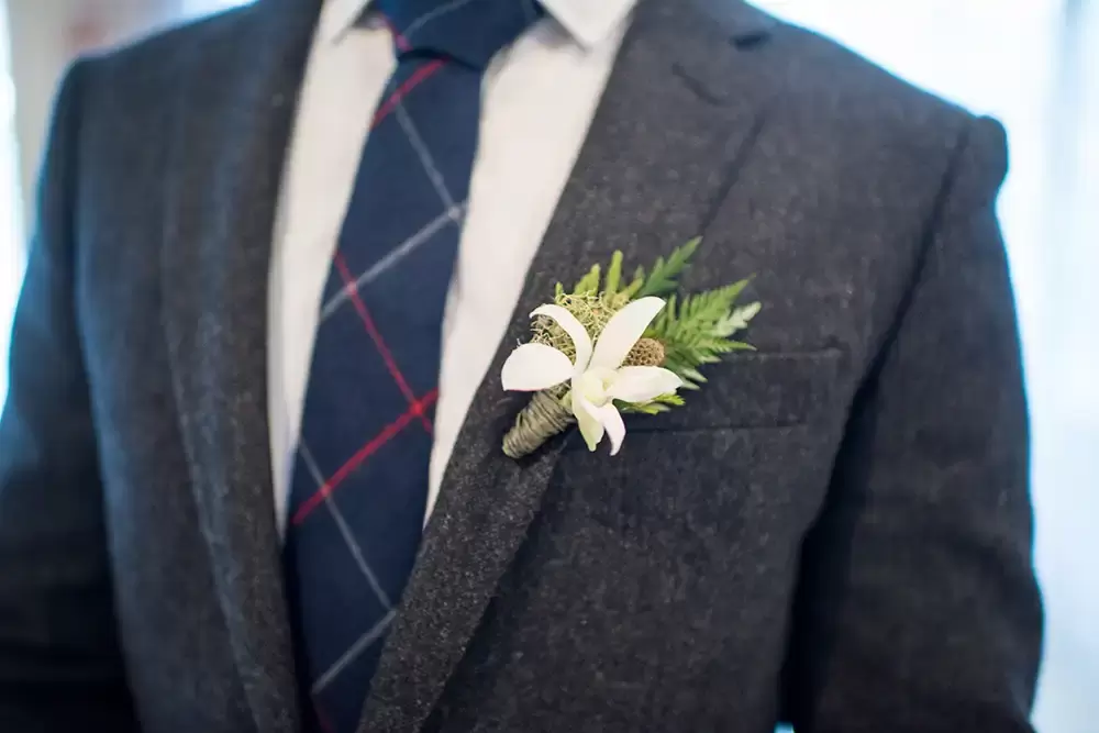 A close-up of the boutinere on the lapel of the groom