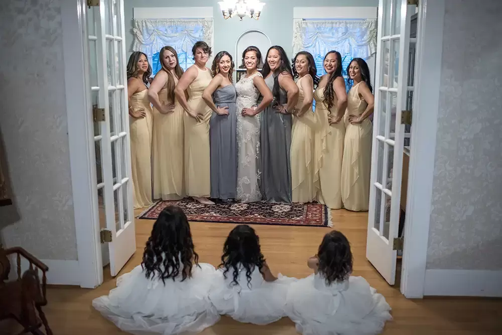 Grey gables estate, the bride and bridesmaids are prepared, all the bridesmaids look to the camera, the flower girls sit and watch the ladies pose