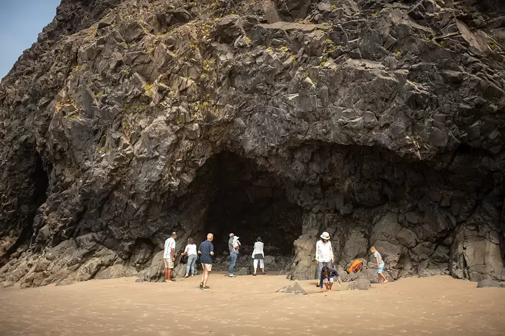 a family explores a cave on the beachPortland ​Family Photographer Robert Knapp - Book Today!